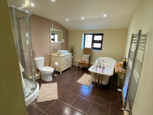 Bathroom with shower and roll top bath