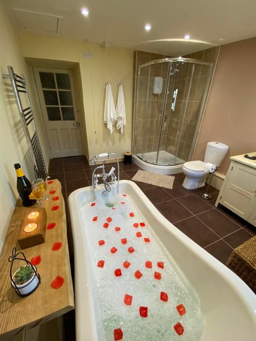 Bathroom with shower and roll top bath