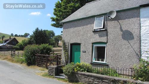 Moelfre Cottage and parking and garden to left.