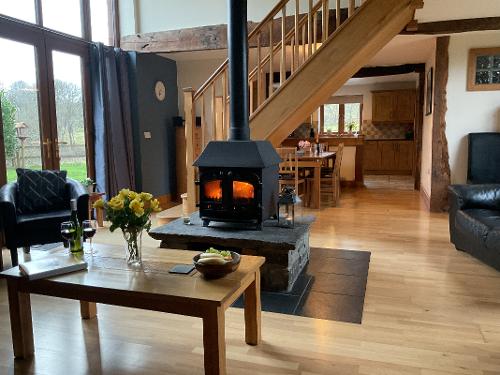 Cosy central wood burner warms up the whole barn.