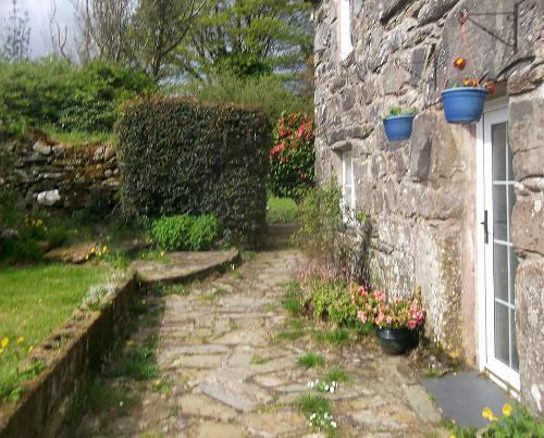 Front of house with garden and patio