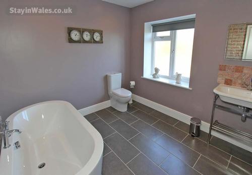 The spacious first floor bathroom, which also has a loo and washbasin.