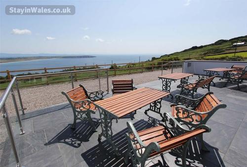 To the front of the house is a terrace with views over Hell''s Mouth Bay and the coastline and Snowd