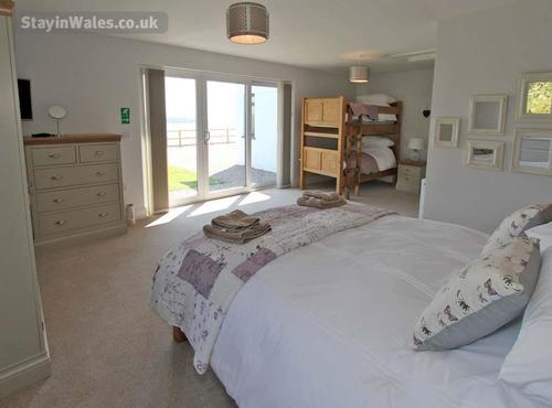 The ground floor family bedroom makes the most of the sea view, and has a kingsize bed plus a bunk t