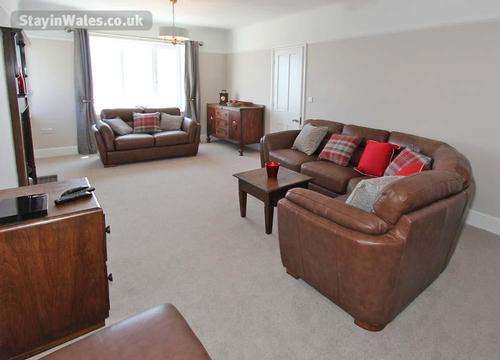 The living room provides another sitting area in addition to the sitting room.