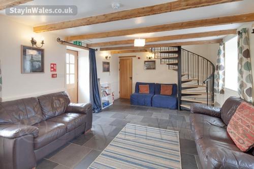 The living room, with spiral staircase to the first floor
