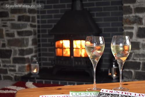 Relax with a glass of wine by the woodburner