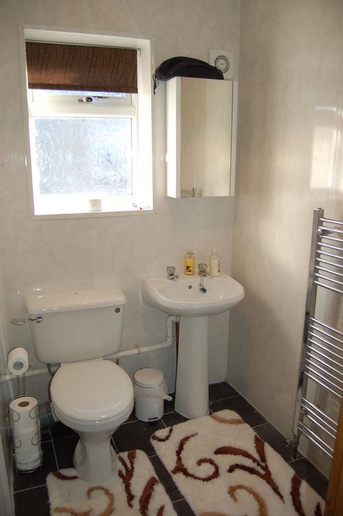 Bathroom suit consists of a toilet, sink and free standing shower. Heated towel rail. Underfloor hea