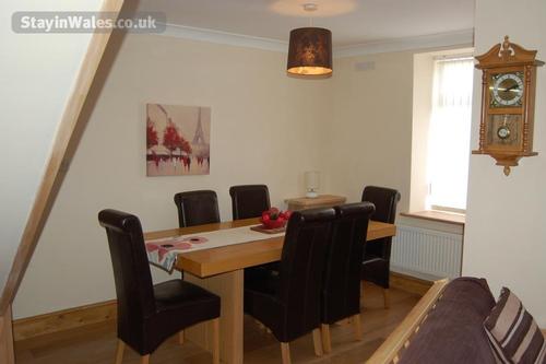 Dining area with dining table seats up to six people, situated in the lounge.