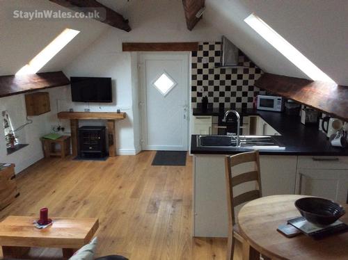 Kitchen and lounge area in Ysgubor Hen