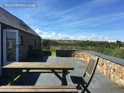 Large slate terrace with garden furniture