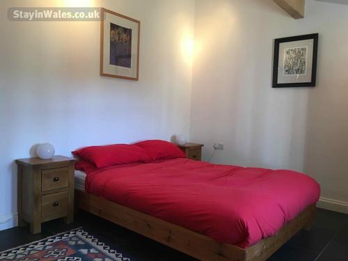 Spacious double bedroom with beams
