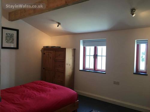 Spacious double bedroom with beams