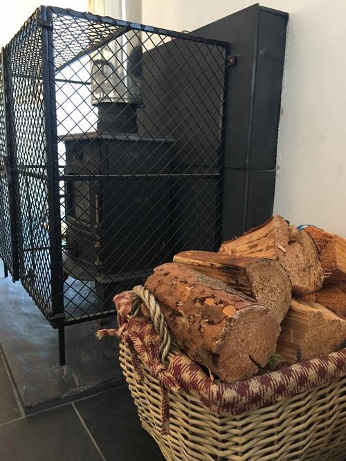 Wood burner with fire guard and basket of logs