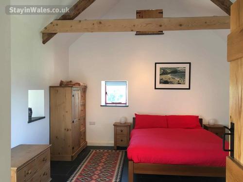 Large master double bedroom with A-frame beams