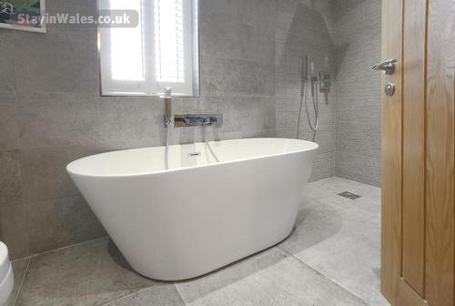 Ty Gambo wet room with stand alone bath and walk in rainforest shower