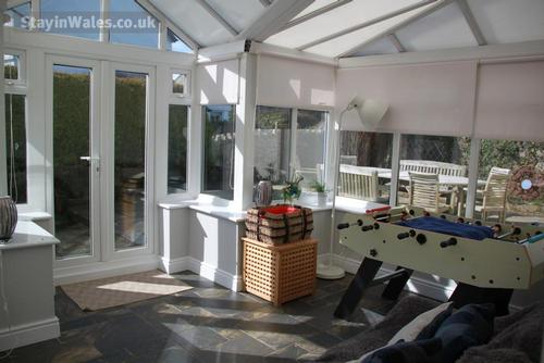Light and warm conservatory with football table