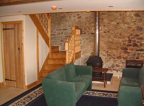 Living room with woodburner in The Barn