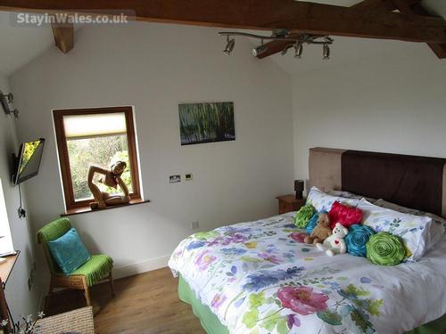 Relax on the comfy super king bed watching the fantastic sunsets over Carmarthen Bay