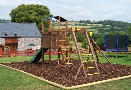 Safe, contained play area with climbing frame, swing and slide.