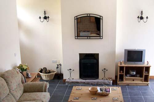 The spacious living area is heated by a woodburner. Logs are provided free of charge.
