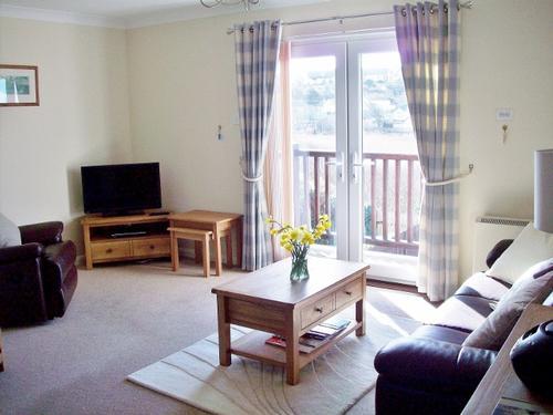First floor living room with balcony and lovely sea views.