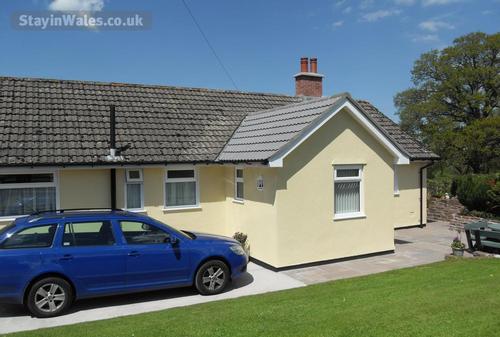 Back of bungalow with parking area.