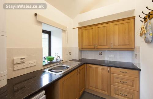 The utility room with coat-hanging space and washing machine