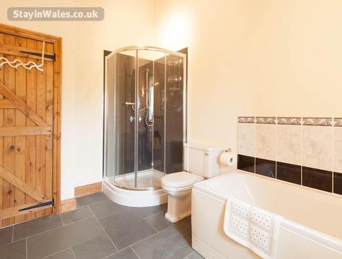 The main bathroom has a bath and separate shower