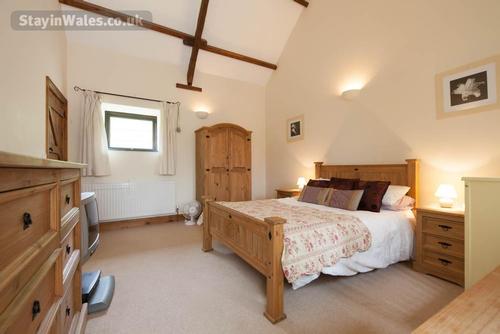 The ground floor double bedroom, which also has a cot