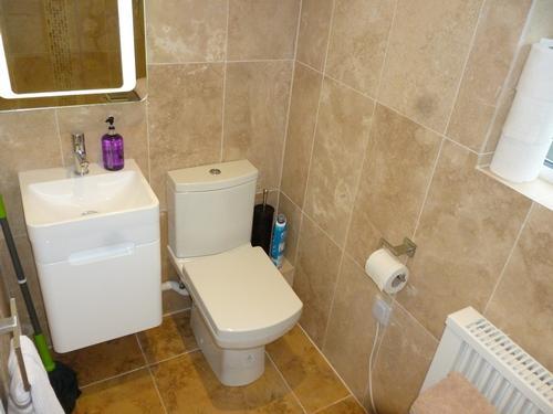 Bathroom with lit mirror and shaving point