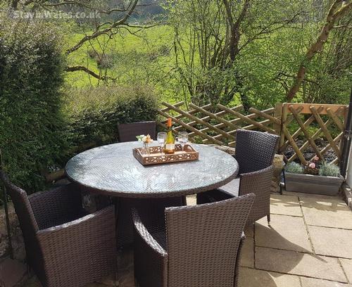 Sunny patio overlooking river and open fields