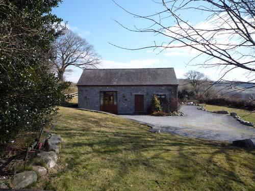 This detached stone barn conversion is in a peaceful, secluded position on a Welsh hill farm