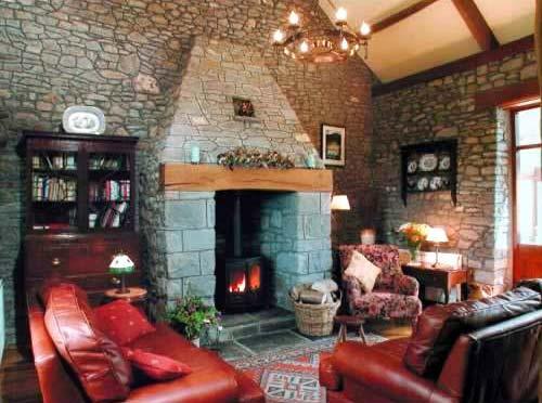 The living room has a stone fireplace with woodburner