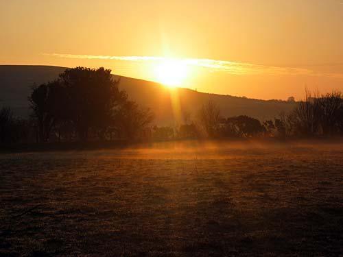 Sunrise over the hills at Trallwyn Cottages.