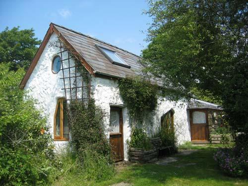Trallwyn Converted Cowshed has curvy stone walls and beams and is full of character and charm.