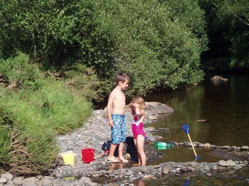 Playing on the river bank in the garden