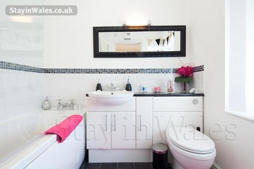 This spacious bath and shower room is en-suite to the double bedroom