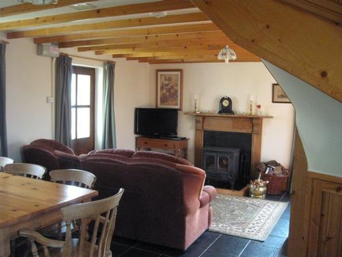 Lounge with wood burner stove. Wood and central heating, that you control, are included in the price