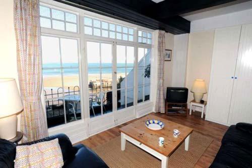 Crwys flat (sleeps max 4) Living room with French windows opening on to a veranda and stairs leading
