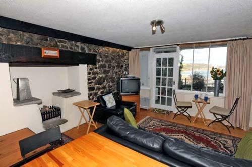 Harbwr flat (sleeps max 5) open plan living room with a door leading outside to the patio overlookin