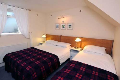 Bedroom in Harbwr with a double king size bed and a single bed. There is also a double sofa bed in t