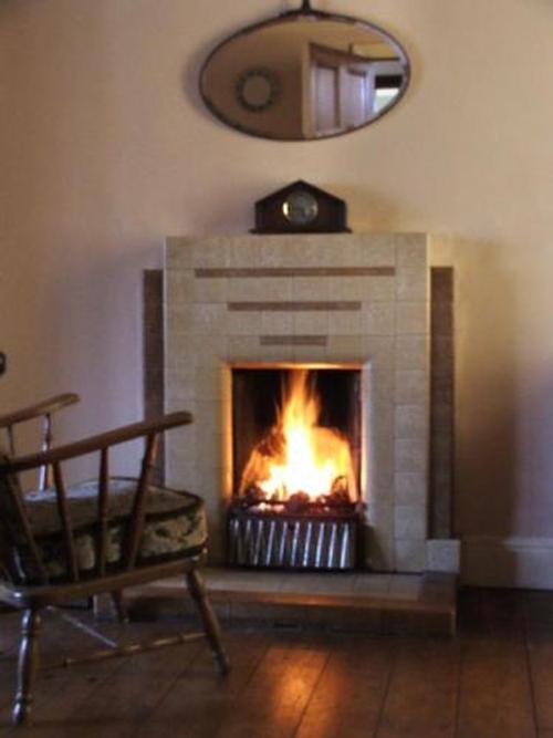 Cosy fire in Piano room.