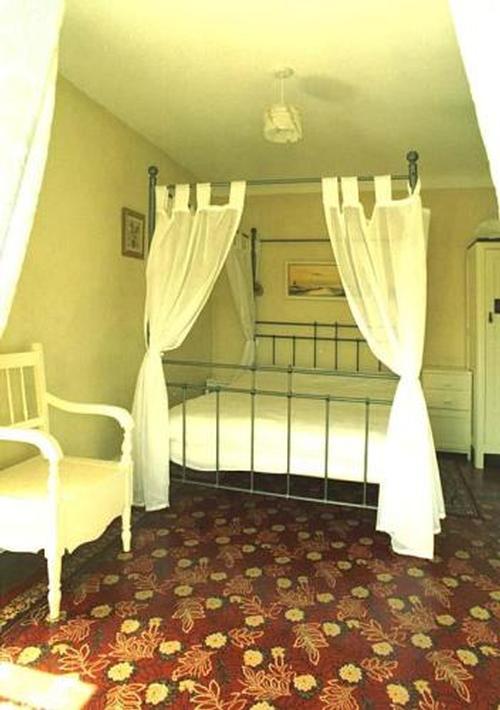 The gorgeous four poster bedroom. Comfy bed and stunning period linoleum beautifully restored, and o