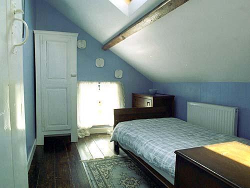 Gorgeous under-eaves single bedroom with luxury bed.