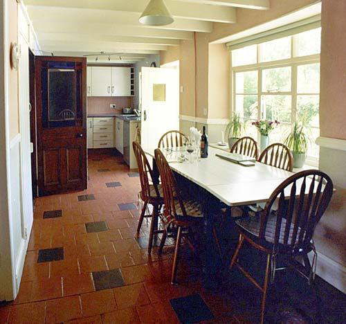 The large kitchen dining room has stunning views over the gardens and pond