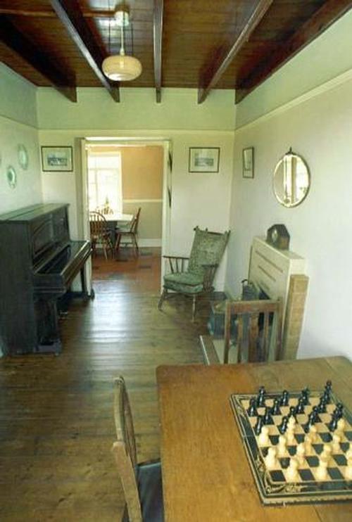 Piano room with lovely period fireplace, plenty of books and games for that cosy evening in, and of
