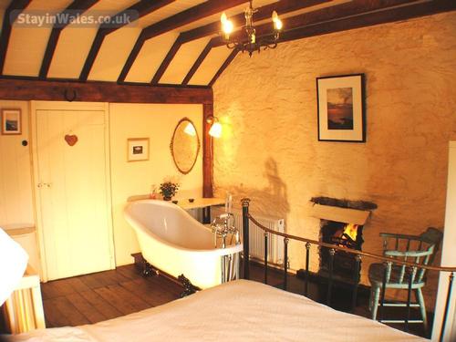 Enjoy a firelit soak in slipper bath