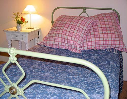 Three quarters size Victorian iron bed in second bedroom