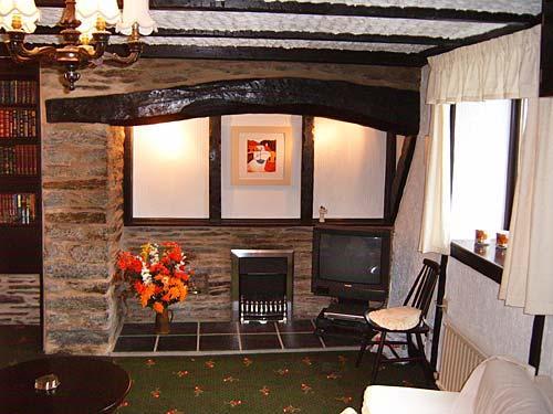 The living room with inglenook fireplace